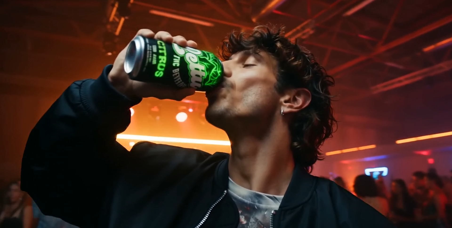Drinking Lettus Citrus in a red-lit nightlife scene